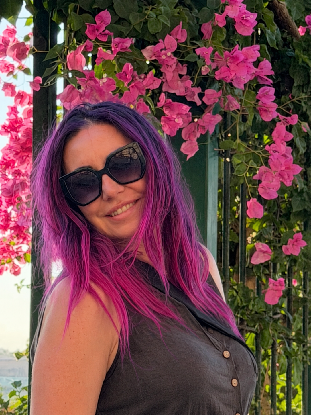 Agnieszka Niziałek in front of pink flowers.